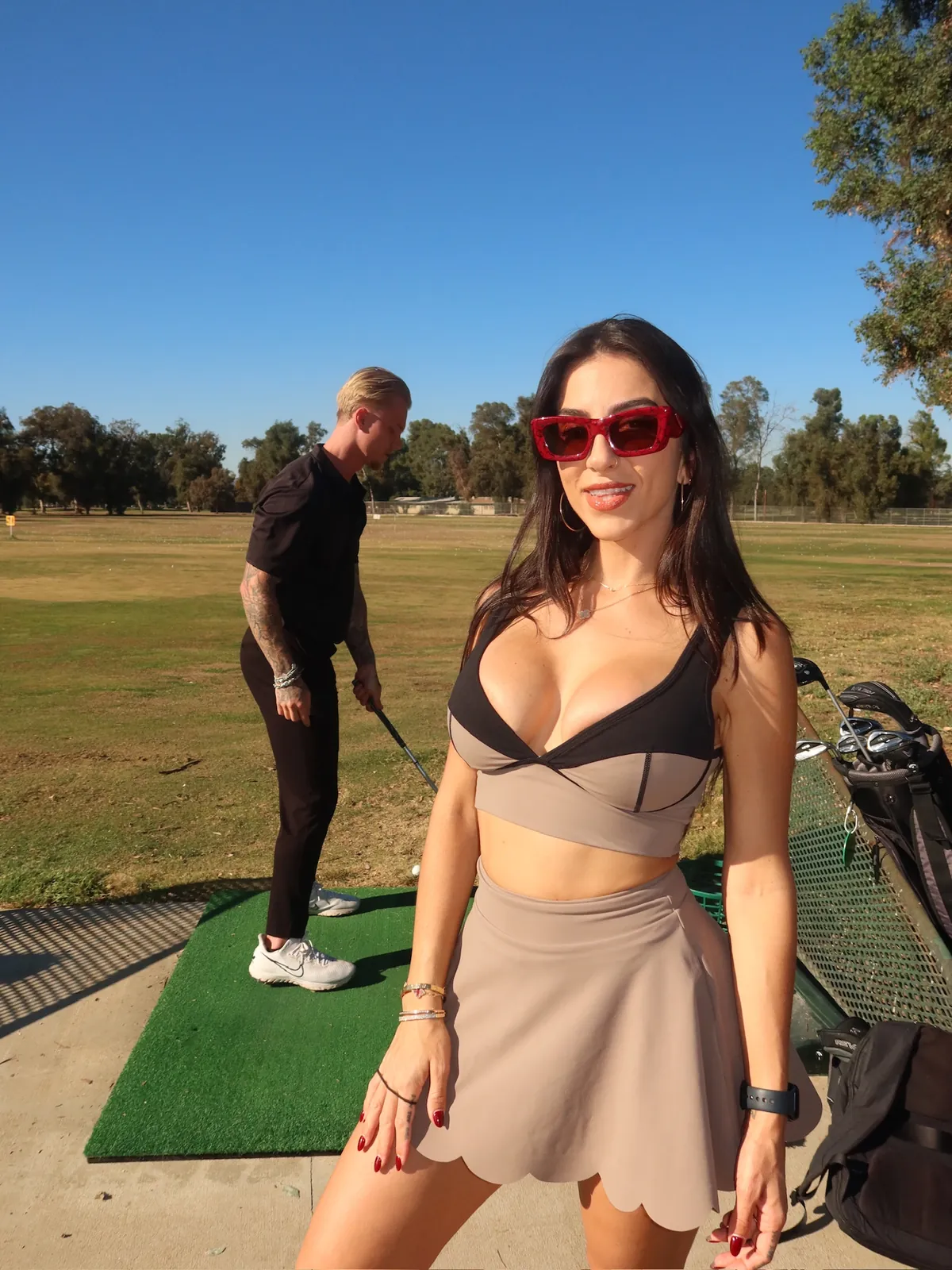 Behind the scenes on set with the ManageHer team at a golf content shoot, Tyler in the background