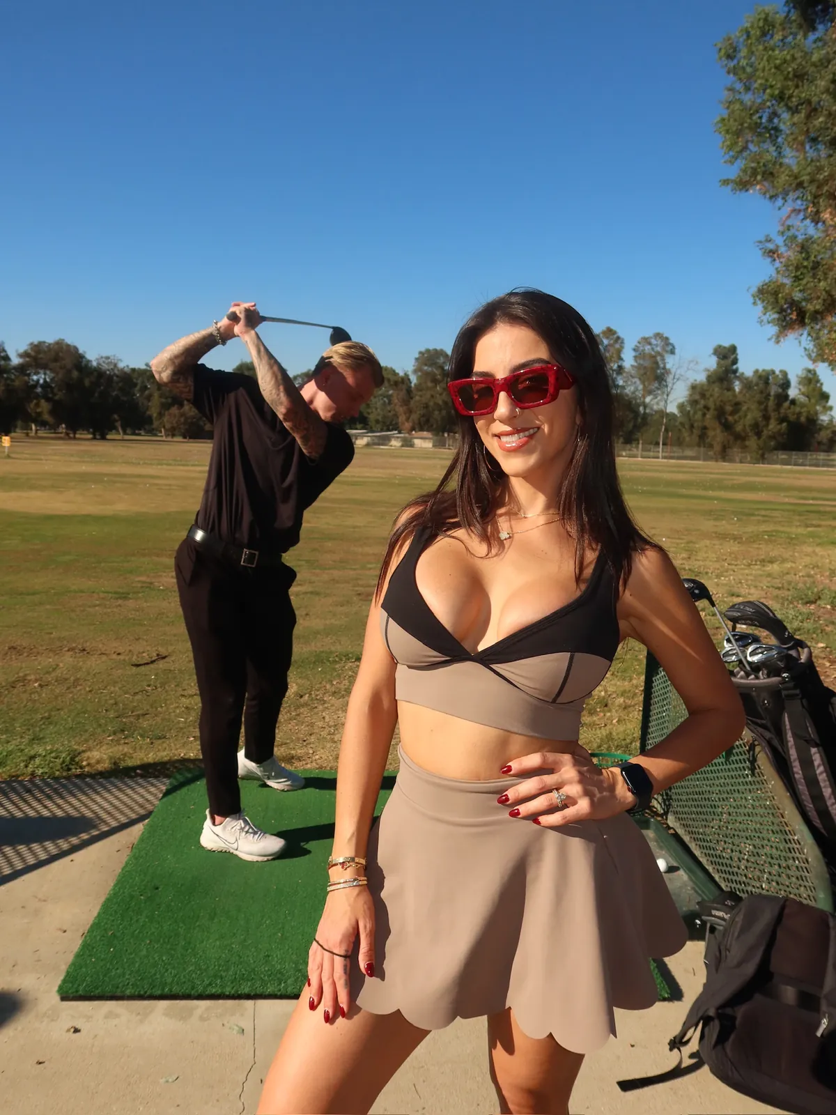 Tyler mid-swing on set with the ManageHer team at a behind-the-scenes golf content shoot
